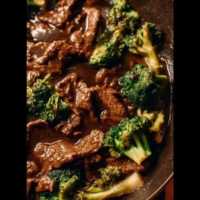 Plate of stir-fried Beef and Broccoli with rice and sauce