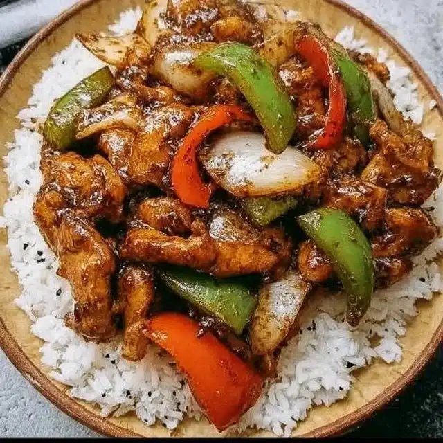 Delicious Black Pepper Chicken served with rice and vegetables