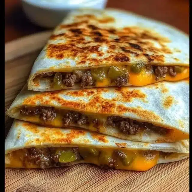 Cheeseburger quesadilla filled with beef, cheese, and jalapenos, grilled to perfection