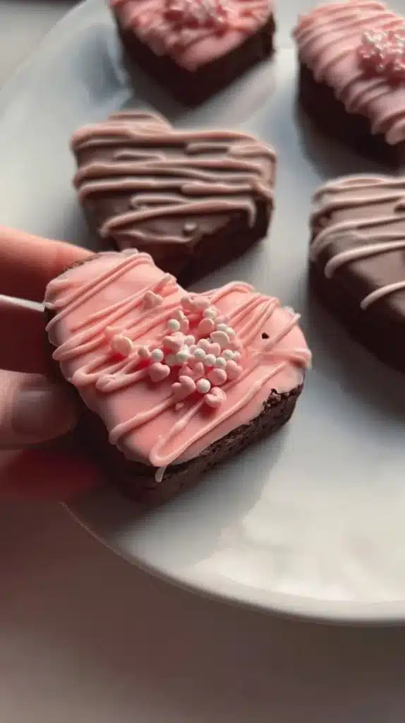 Delicious chocolate dipped heart brownies on a white plate