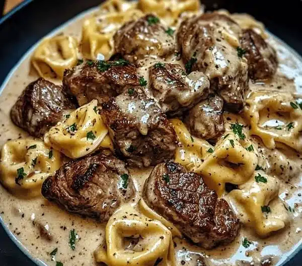 Delicious Cracked Garlic Steak Tortellini in Creamhouse Sauce served in a bowl