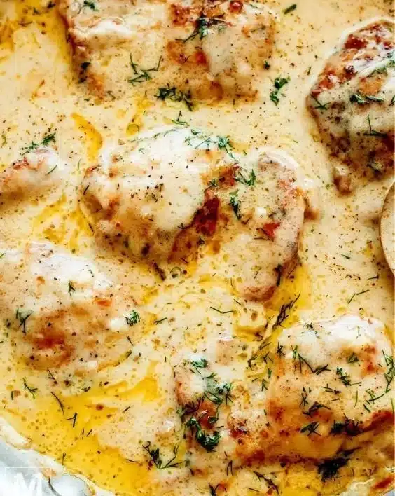 Creamy oven baked chicken thighs served with herbs and spices