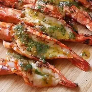 Home 1 Grilled garlic confit butter BBQ butterflied prawns on a serving platter