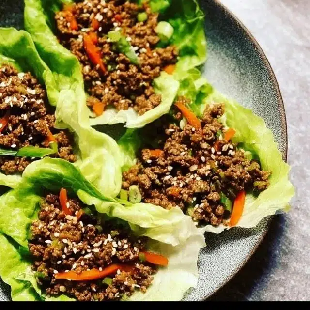 Delicious ground beef lettuce wraps served on a plate with fresh ingredients