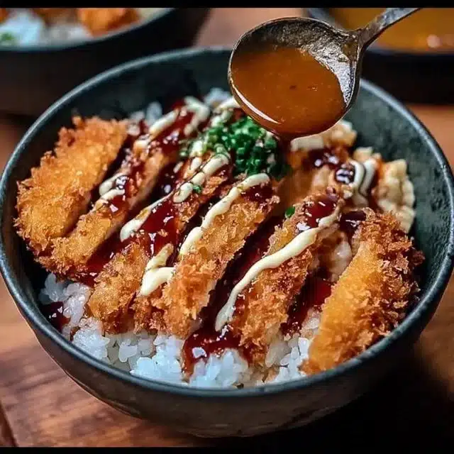 Delicious Japanese Katsu Bowl with Tonkatsu Sauce served on a plate.