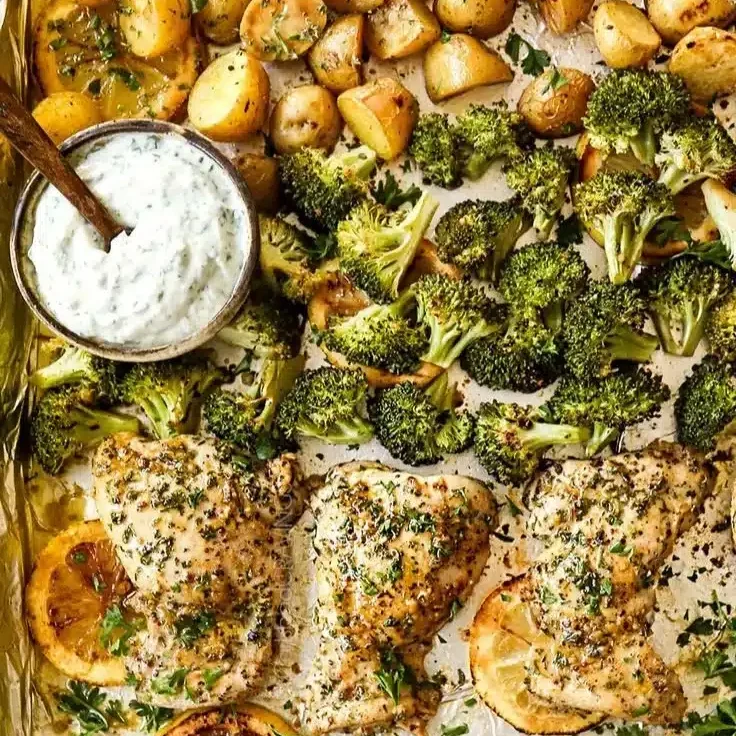 Home 2 Lemon garlic chicken with potatoes and broccoli on a sheet pan ready to serve.