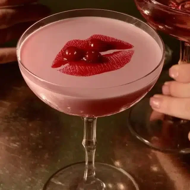 Home 6 Image of a Pink Squirrel cocktail garnished with cherry and cream