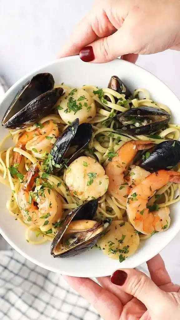 Bowl of seafood pasta in white wine garlic butter with shrimp and scallops