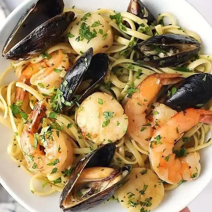 Home 4 Bowl of seafood pasta in white wine garlic butter with shrimp and scallops