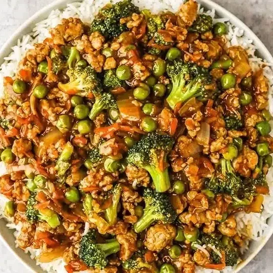Plate of teriyaki ground turkey with broccoli and peas
