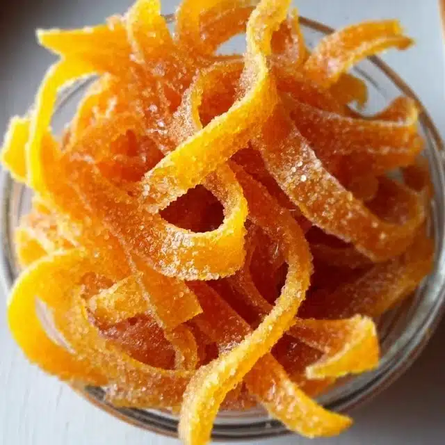 Easy candied orange peel recipe with orange slices in syrup.